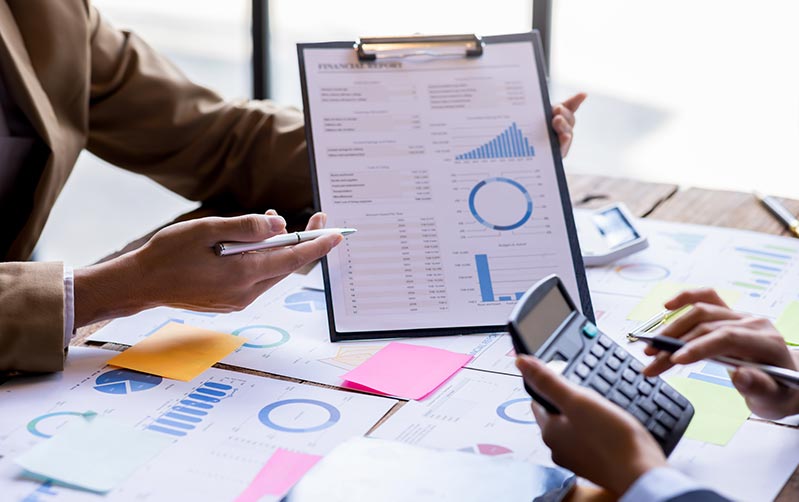 Brisbane based financial advisor showing reports in a consultation