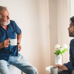 Son is talking with his father about the family home and aged care fees